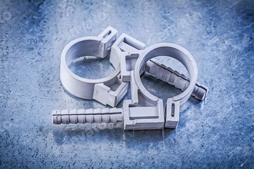Preview: Pvc Pipe Clamps On Metallic Background Construction Concept.