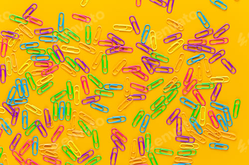 Preview: Color Paper Clips On Yellow Background, Copy Space. Top View, Flat Lay. Back To School, College