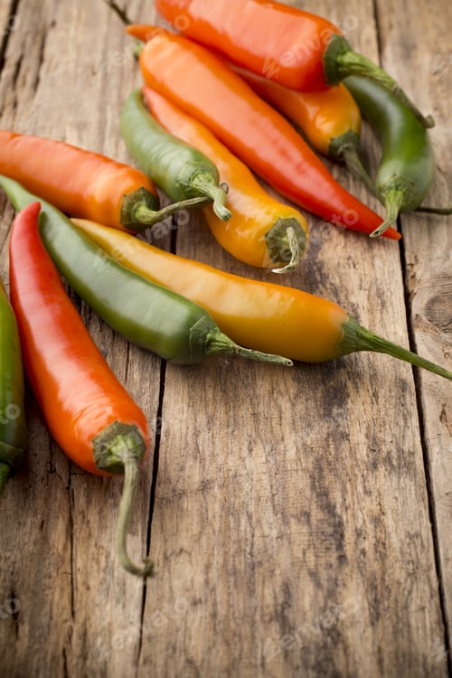 Preview: Chili Pepper Mix On A Wooden Background.