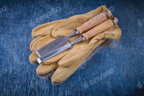 Preview: Flat Chisels And Pair Of Leather Protective Gloves On Scratched Metallic Background Construction