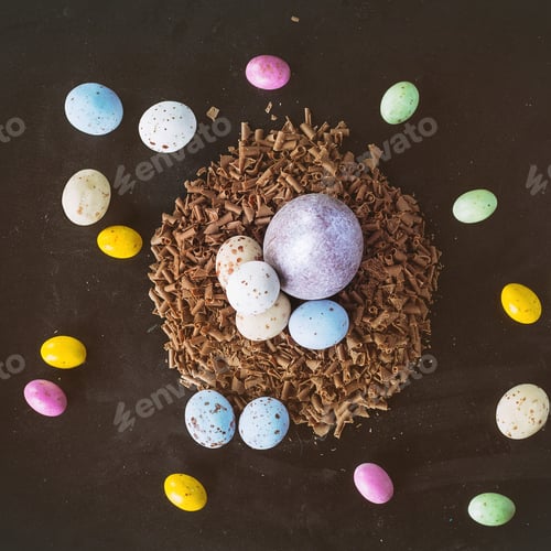 Preview: Traditional Chocolate Colored Easter Eggs Decorated With Chocolate Chips Over Dark Background. Top