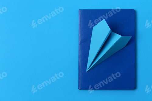 Preview: Airplane Made Of Paper And Passport On A Blue Background With Copy Space For Placing An Inscription