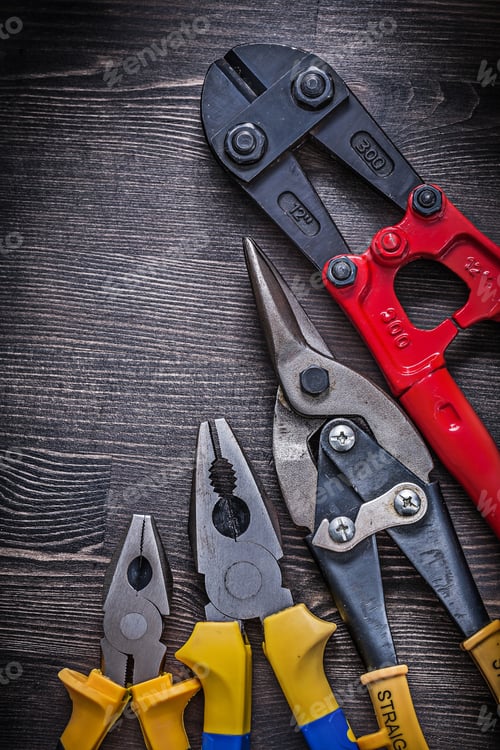 Preview: Metal Wire Steel Cutter Pliers On Wood Board Construction Concept.