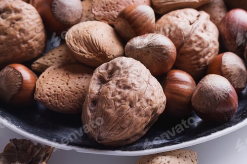 Preview: Selection Of Almonds In The Vintage Ceramic Plate, Black Background, Top View