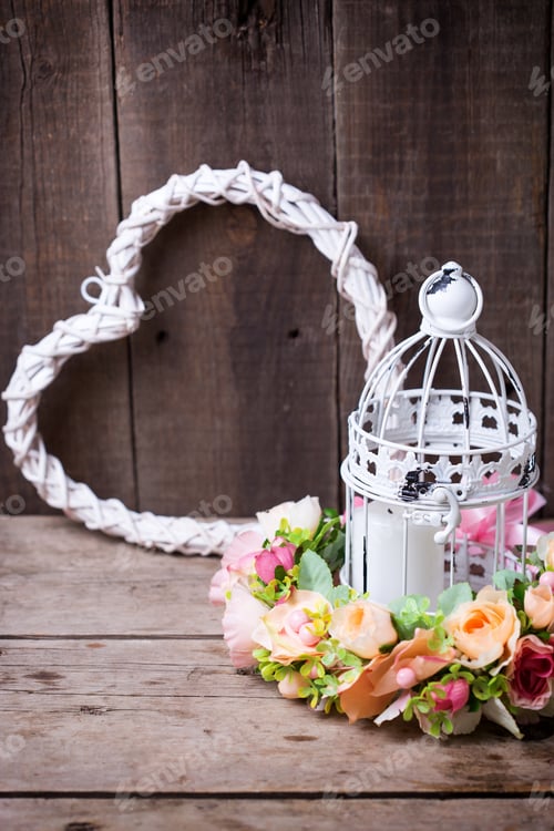 Preview: Flower Wreath, White Heart And Decorative Lantern With Candle On Wooden Background. Still Life