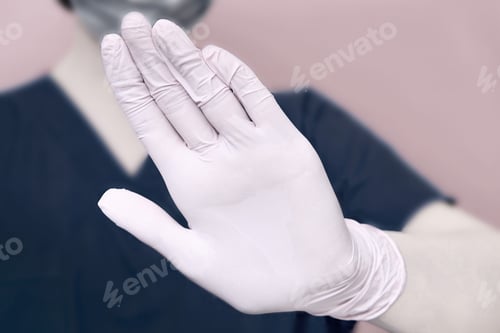 Preview: The Doctor Shows With His Hand A Prohibiting Gesture Of The Feet, Close-Up. Hand In A Medical Glove