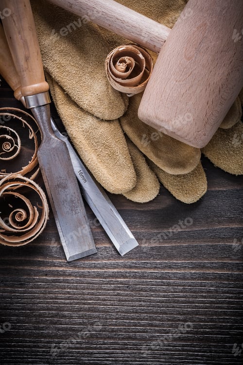 Preview: Brown Leather Gloves Flat Chisels Wooden Hammer And Shavings On Vintage Wood Board Construction