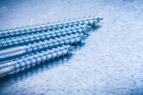 Preview: Group Of Threaded Metal Screw Bolts On Metallic Background Construction Concept.