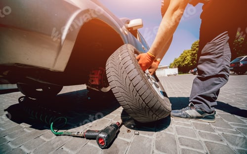 Preview: Professional Car Mechanic Replace Tire On Wheel. Auto Repair Service.