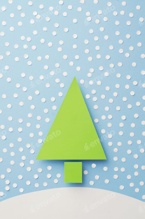 Preview: Paper Christmas Tree And Paper Snow Cut From Green Paper Over Blue Background,Top View