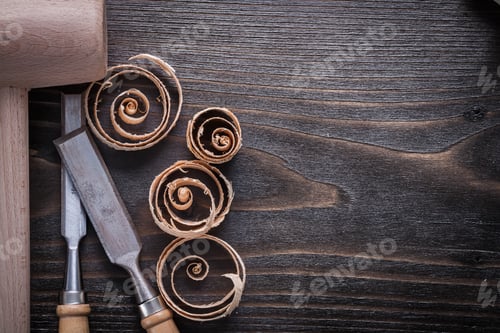 Preview: Wooden Hammer Flat Chisels And Curled Up Shavings On Vintage Wood Board Copy Space Image