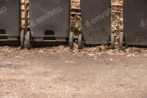 Preview: Four Grey Garbage Cans On Wheels