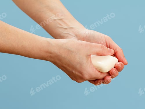 Preview: Close Up View Of Woman Washing Hir Hands With Soap On A Blue Background. Correctly Cleaning Hands