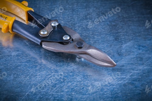 Preview: Steel Cutter On Scratched Vintage Metallic Background Construction Concept.