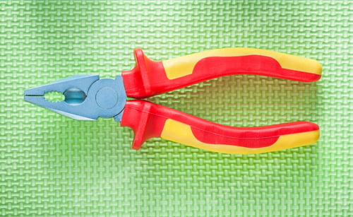 Preview: Insulation Pliers On Green Surface Electricity Concept.