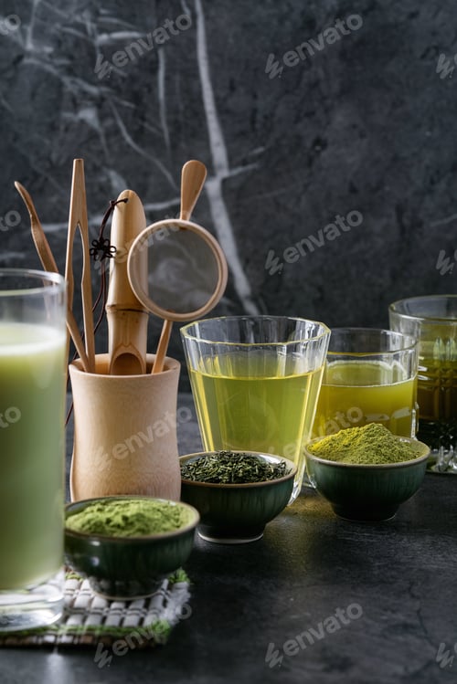 Preview: Variety Of Matcha Tea Served With Sencha And Matcha Powder Over Dark Wooden Background