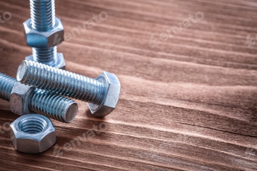 Preview: Collection Of Metal Bolts And Screw Nuts On Vintage Wooden Board Construction Concept
