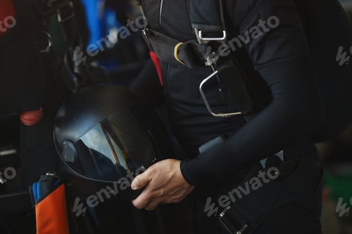 Preview: Black Hard Helmet For Skydiving In The Hands Of A Skydiver, Close-Up. Parachute Equipment.