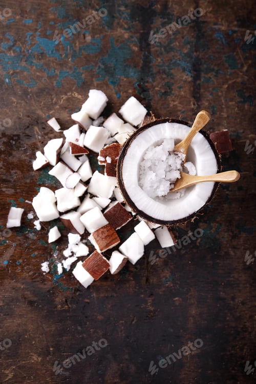 Preview: Organic Coconut Oil Served With Coconuts, Shells And Bits Of Coconut Decorated With A Sppon Over A