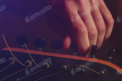 Preview: Young Handsome Creative Man With A Guitar In The Darkness Of A Music Studio, Toned Background