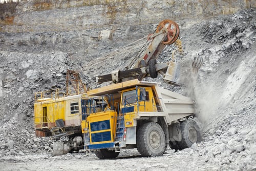 Preview: Excavator Loads The Destroyed Rock Into The Body Of A Mining Dump Truck On The Background Of An