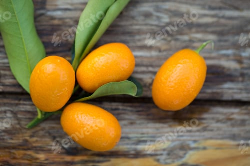 Preview: Fresh Raw Kumquat Fruits, The Chinese Mandarins, On A Wooden Board