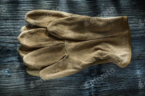 Preview: Leather Protective Gloves On Wooden Board Top View.