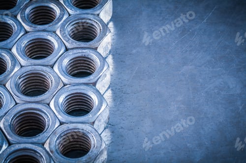 Preview: Collection Of Threaded Screw-Nuts On Scratched Metallic Background Construction Concept.
