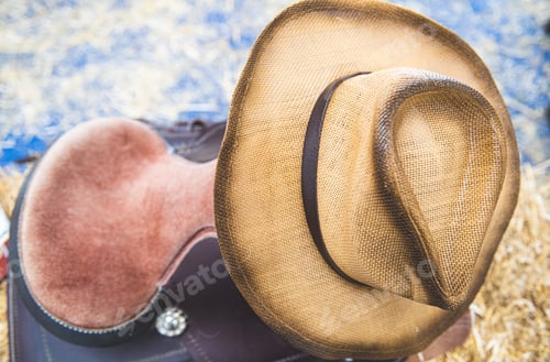 Preview: Close-Up Of Cowboy Hat And Horse Saddle In A Store On Tumbleweed Straw Bale, American Style Riding