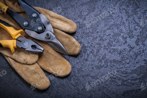 Preview: Steel Cutter Pliers Leather Safety Glove On Black Background.