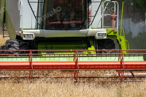 Preview: Harvester At Work On The Field Harvesting Ripe Wheat