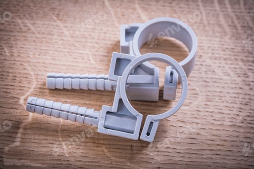 Preview: Polypropylene Fixators For Pipes On Wooden Board