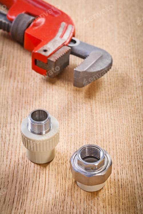 Preview: Plumbing Fixtures And Monkey Wrench On Wooden Board