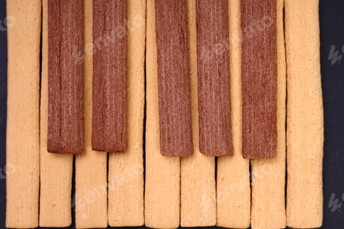 Preview: Light And Dark, Black And White Fitness Cookies With Fiber Laid Out In The Form Of Piano Keys