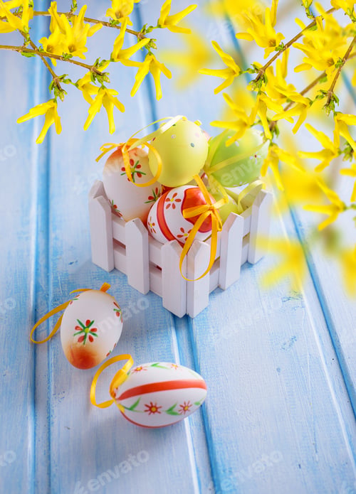 Preview: Colorful Easter Eggs In Box On Blue Painted Wooden Planks. Easter Background.