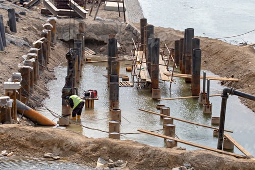 Preview: Welder Wearing Protective Clothing And Welding Industrial Construction For Erosion Control. River
