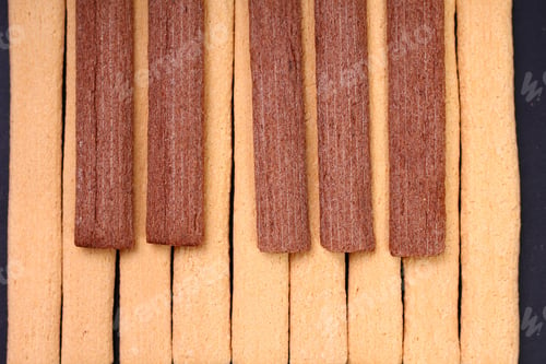 Preview: Light And Dark, Black And White Fitness Cookies With Fiber Laid Out In The Form Of Piano Keys