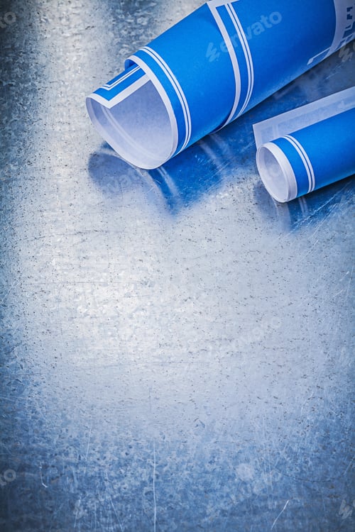 Preview: Blue Rolled Blueprints On Metallic Background Construction Concept.