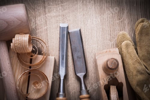 Preview: Wooden Bricks Mallet Curled Up Shavings Planer Firmer Chisels Leather Gloves On Wood Background