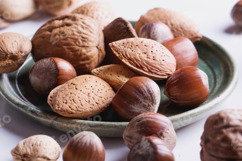 Preview: Selection Of Various Nuts In The Vintage Ceramic Plate, Black Background, Top View