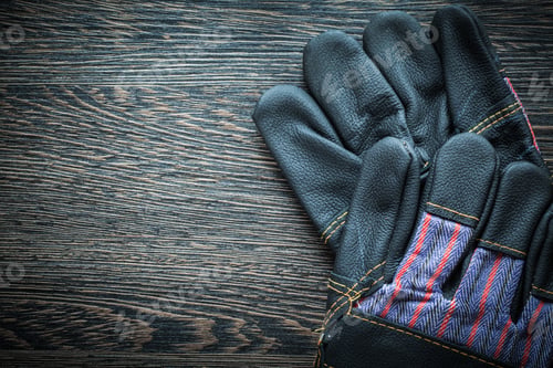 Preview: Pair Of Leather Protective Gloves On Wooden Board.