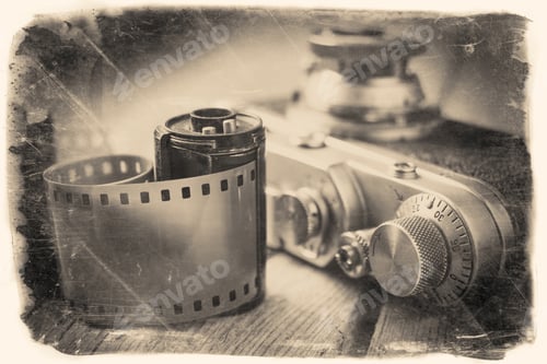 Preview: Old Photo Film Roll And Retro Camera On Desk. Vintage Stylized Photo.
