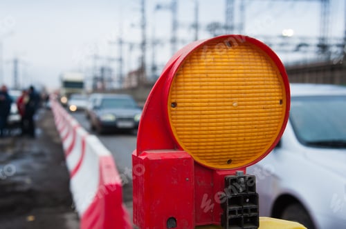 Preview: Repair Of Asphalt Pavement. Orange Construction Light On Barricade And Red Safety Barriers On The