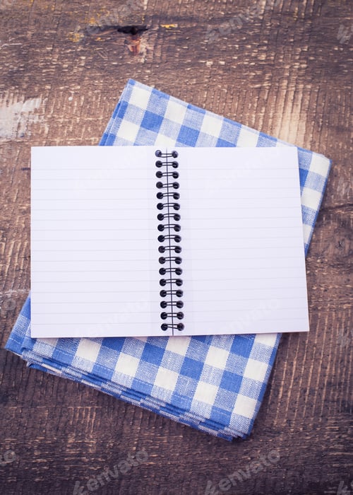 Preview: Open Notebook On Towel On Vintage Wooden Background. Retro Style.