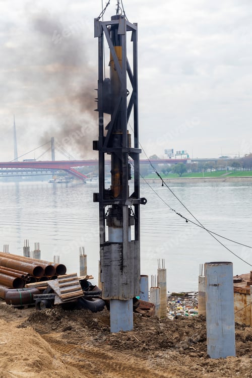 Preview: Pipe Piles Being Driven Into The Ground. Metal Pillars Foundation Building.