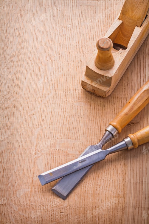 Preview: Woodworkers Plane And Carpentry Chisel On Wooden Board With Organized Copyspace Construction Concept