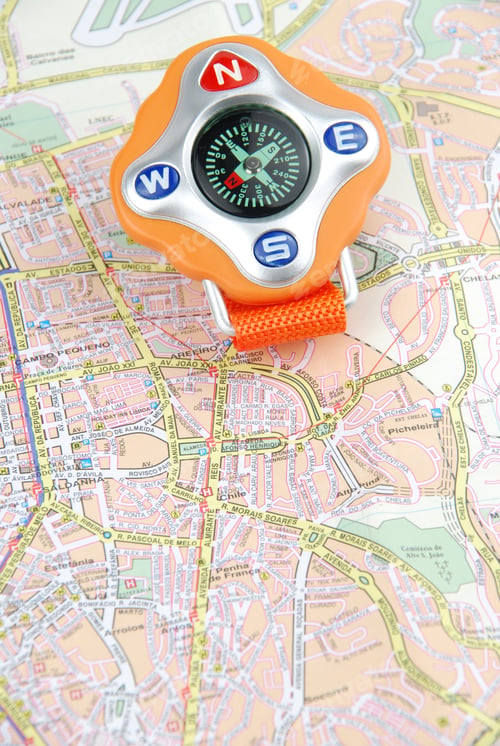 Preview: Orange Compass On A City Map (Travel/Orientaion Concept)