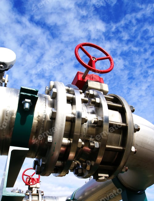 Preview: Industrial Zone, Steel Pipelines And Valves Against Blue Sky