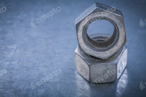Preview: Threaded Construction Nuts On Metallic Background Maintenance Concept.