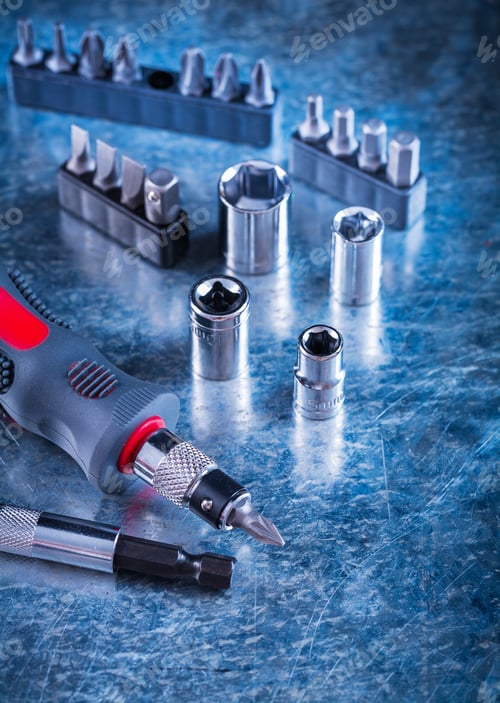 Preview: Toolset Of Insulated Screwdriver With Replaceable Heads And Bits On Scratched Metallic Surface